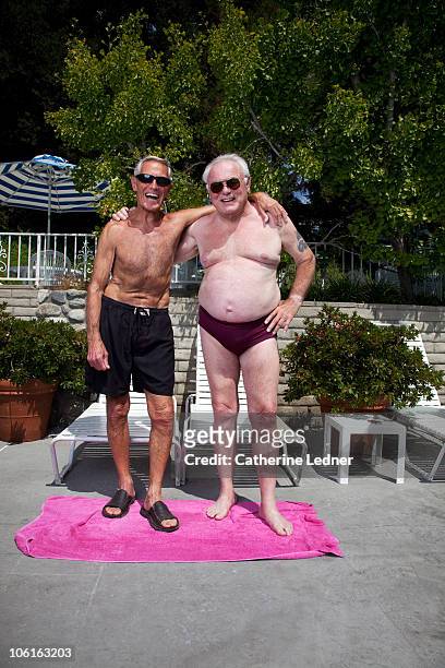 two senior men in bathing suits laughing - man wearing speedo stock-fotos und bilder