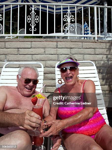 senior couple enjoying drinks while sunbathing. - jovem de espírito - fotografias e filmes do acervo
