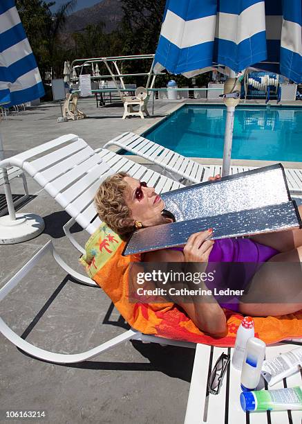 portrait of senior woman tanning her face. - sunbathing stock pictures, royalty-free photos & images
