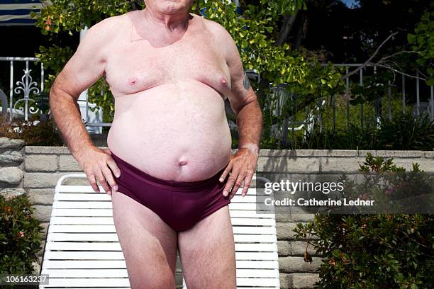 close up of senior man's stomach - fat man speedo stock pictures, royalty-free photos & images