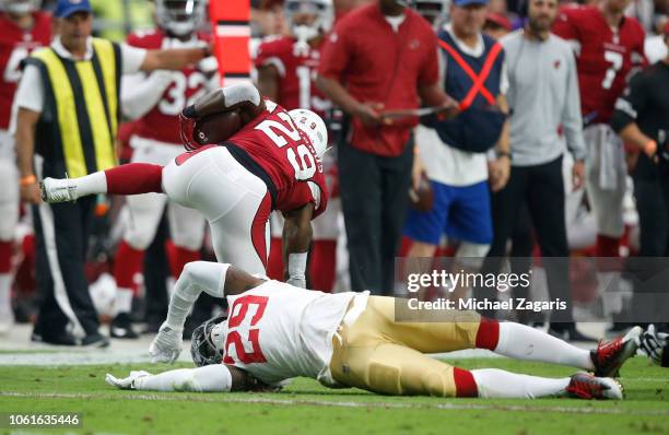 Jaquiski Tartt of the San Francisco 49ers trips up Chase Edmonds of the Arizona Cardinals during the game at State Farm Stadium on October 28, 2018...