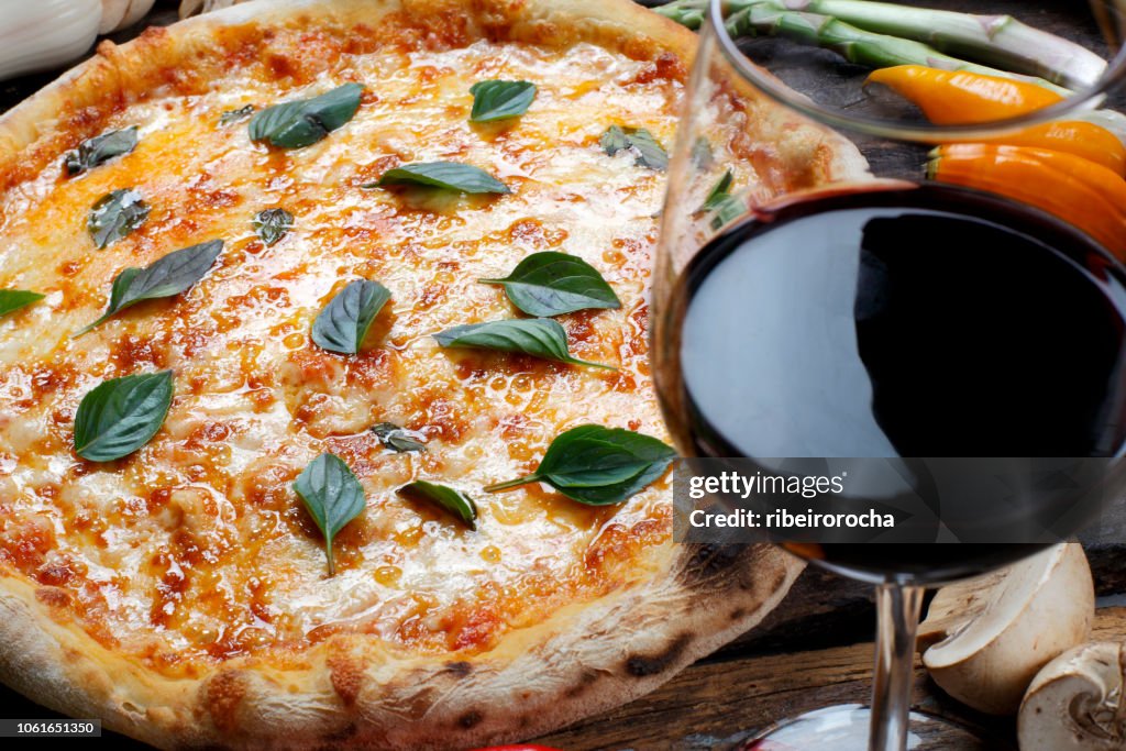 Pizza with glass of red wine