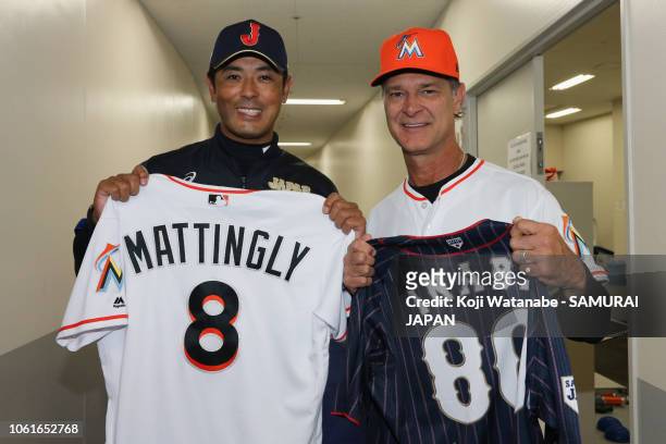 Head coach Atsunori Inaba of Japan and Manager Don Mattingly of the Miami Marlins exchange their uniforms prior to the game six between Japan and MLB...