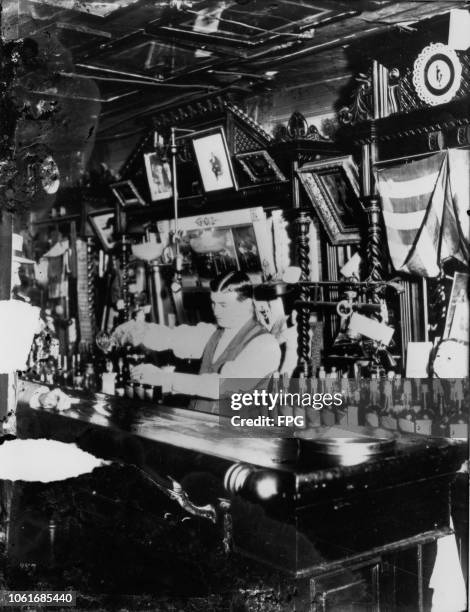 Steve Brodie serves drinks at his establishment, Steve Brodie's Saloon at 114 Bowery, New York City, circa 1890. Steve Brodie gained publicity for...