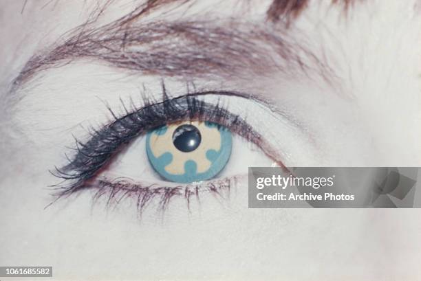 An eye with a patterned 'psychedelic' contact lens, circa 1970.