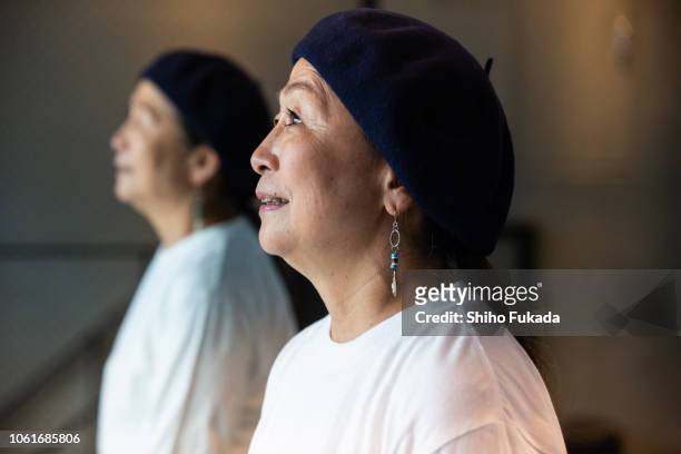 a japanese active senior woman performs street-style dance in dance studio and street. - showus ストックフォトと画像