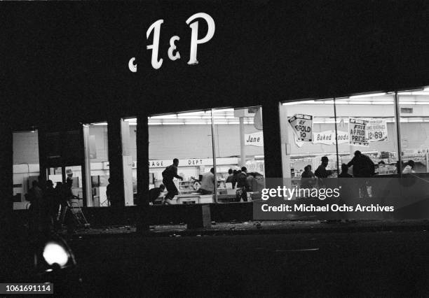 Looting in an A&P store during riots in Washington, DC, following the assassination of civil rights activist Martin Luther King Jr., April 1968.