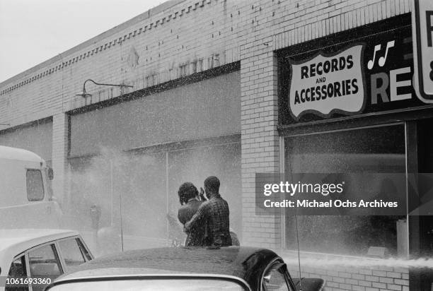 Fire fighters use fire hoses to subdue the protestors during the Birmingham Campaign in Birmingham, Alabama, May 1963. The movement, which called for...