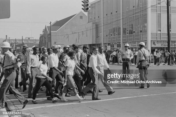 African Americans marching on the corner of 16th Street and 5th Avenue in Birmingham, Alabama, at the start of the Birmingham Campaign, May 1963. The...
