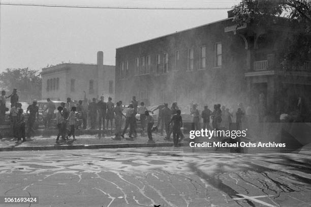 Fire fighters use fire hoses to subdue the protestors during the Birmingham Campaign in Birmingham, Alabama, May 1963. The movement, which called for...