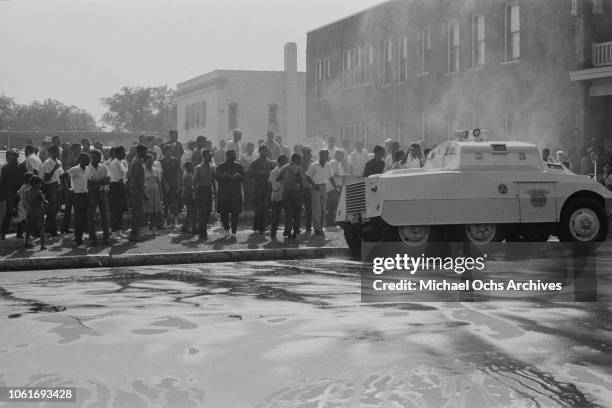 Fire fighters use fire hoses to subdue the protestors during the Birmingham Campaign in Birmingham, Alabama, May 1963. The movement, which called for...