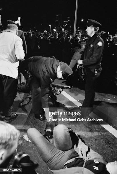 Police officers and protestors outside the Republican National Convention in Cow Palace, Daly City, California, following the nomination of...