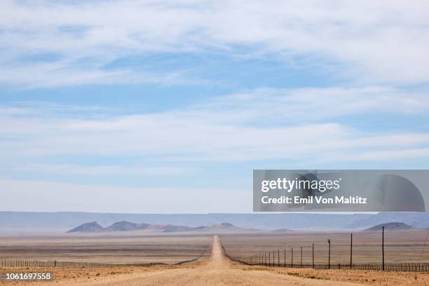 the seemingly endless view of route d707 (namibia's dream road) on the way to sesriem from luderitz, namibia. - bumpy road stock pictures, royalty-free photos & images