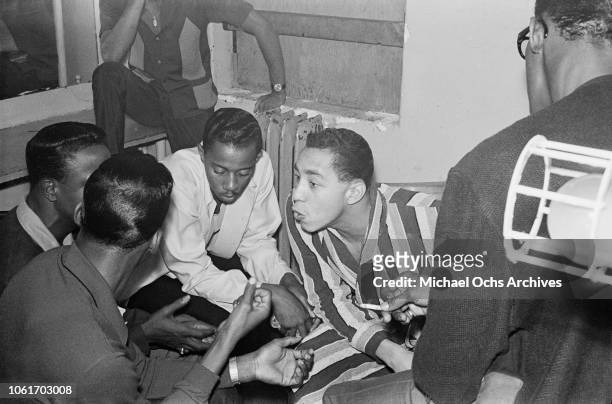 American singer and songwriter Smokey Robinson rehearses the song 'My Girl' with the Temptations in their dressing room at the Apollo Theater, New...