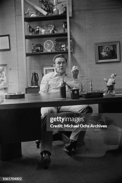 American country music singer and television host Jimmy Dean in his office, USA, November 1964. He is being interviewed by Jim Delehant for 'Country...