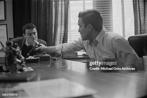 American country music singer and television host Jimmy Dean in his office, USA, November 1964. He is being interviewed by Jim Delehant for 'Country...