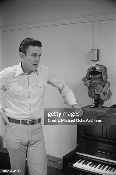 American country music singer and television host Jimmy Dean in his office, USA, November 1964. He is being interviewed by Jim Delehant for 'Country...