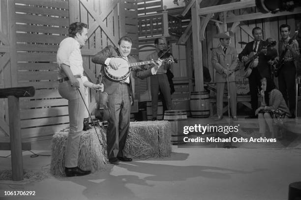 American country music singer and television host Jimmy Dean with guest musician Roy Clark on the set of 'The Jimmy Dean Show', USA, 13th November...