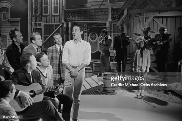 American country music singer and television host Jimmy Dean rehearses with the Chuck Cassey singers on the set of 'The Jimmy Dean Show', USA, 13th...