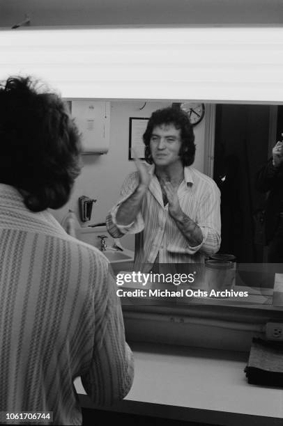 American country singer Larry Gatlin prepares for an appearance on Johnny Cash's television show at the NBC studios, USA, 11th December 1973.