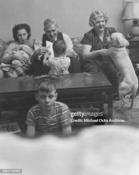 Three generations of a family watching television together in the United States, 1955.