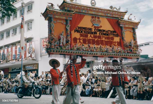 Procession in Hong Kong to celebrate the coronation of Queen Elizabeth II in London, June 1953. The Chinese Coronation Procession Committee march by...