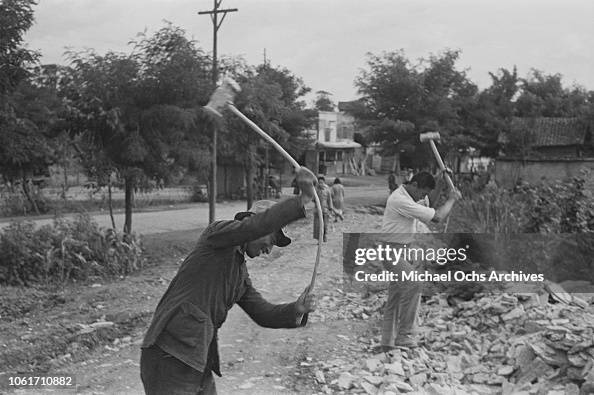 Men breaking rocks by the roadside in China, circa 1950. News Photo ...