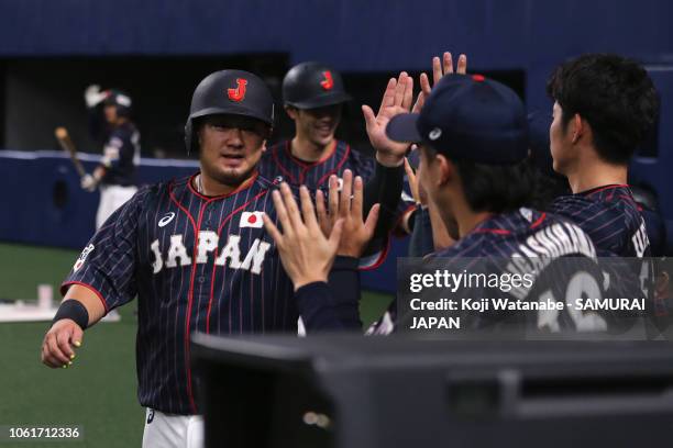 Infielder Hotaka Yamakawa, Catcher Tomoya Mori of Japan and Infielder Shuta Tonosaki of Japan celebrate scoring runs after Infielder Sosuke Genda...