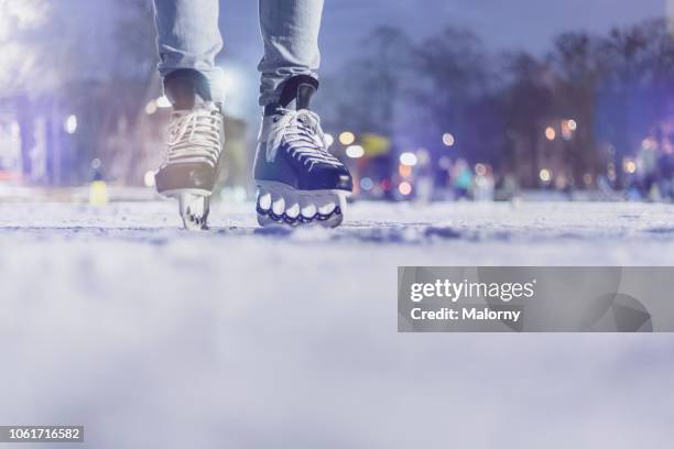 close-up of feet with ice skates on frozen lake. bokeh in the background. winter. - アイススケート ストックフォトと画像