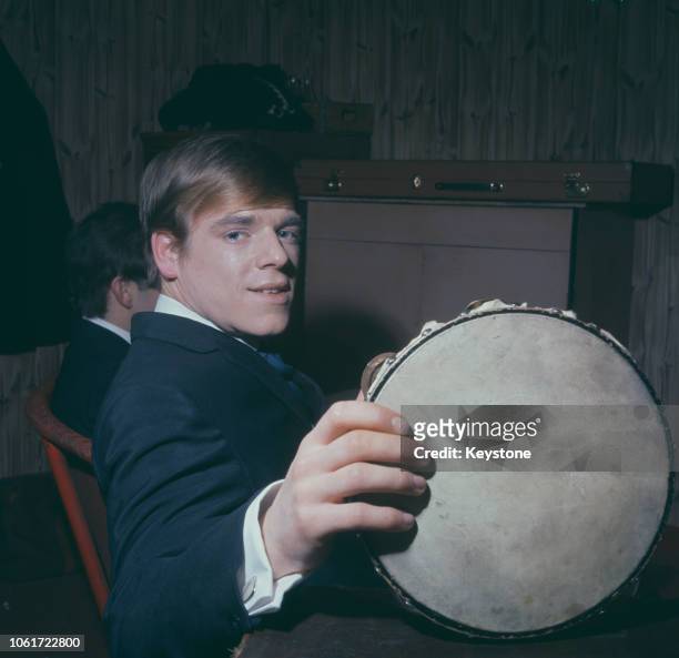 English musician Lenny Davidson, the guitarist for The Dave Clark Five, holding a tambourine, circa 1965.