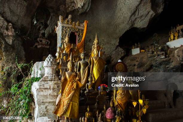 Thousands of Buddha statues are in the Tham Ting of the Pak Ou Caves, situated in a limestone mountain above the Mekong River near Luang Prabang in...
