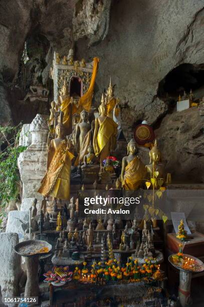 Thousands of Buddha statues are in the Tham Ting of the Pak Ou Caves, situated in a limestone mountain above the Mekong River near Luang Prabang in...