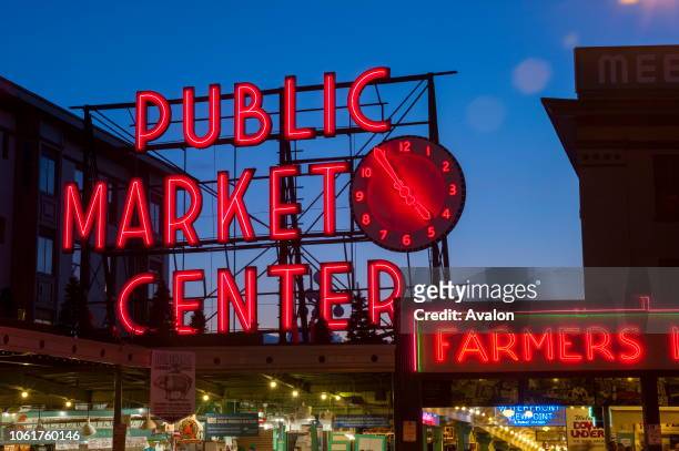 Night photo of the neon sign over the main entrance to the Pike Place Market in Seattle, Washington State, USA.