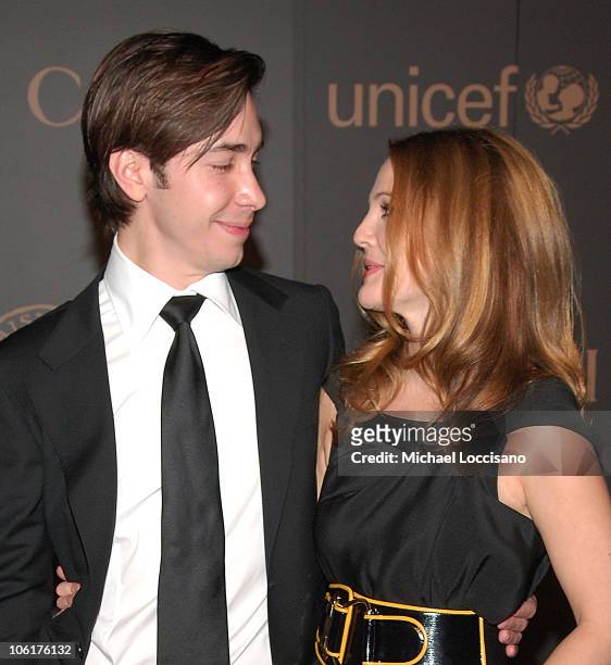 Actor Justin Long and actress Drew Barrymore attend "A Night To Benefit Raising Malawi & UNICEF", hosted by Madonna and Gucci, at The United Nation...