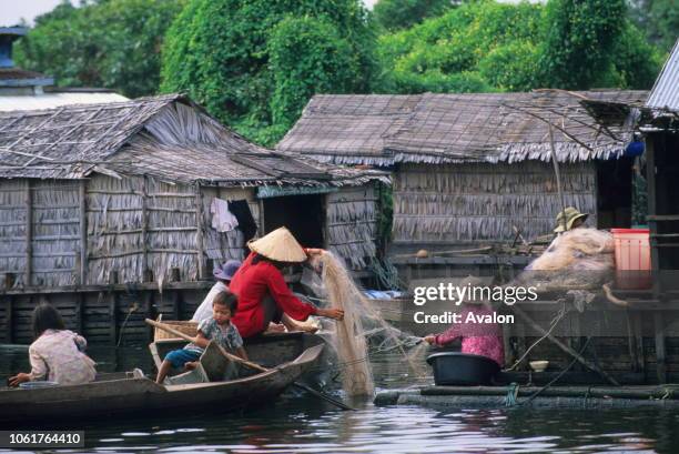 People working on fishing net in the floating village on Tonle Sap Lake near Siem Reap in Cambodia.