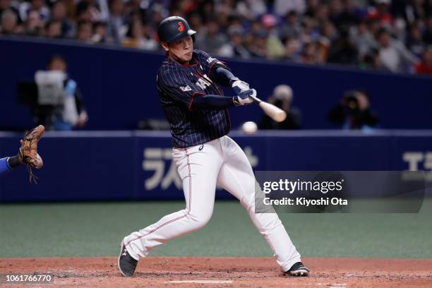 Infielder Kazuma Okamoto of Japan strikes out in the top of 5th inning during the game six between Japan and MLB All Stars at Nagoya Dome on November...
