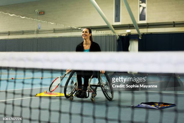 A woman in a wheelchair playing tennis