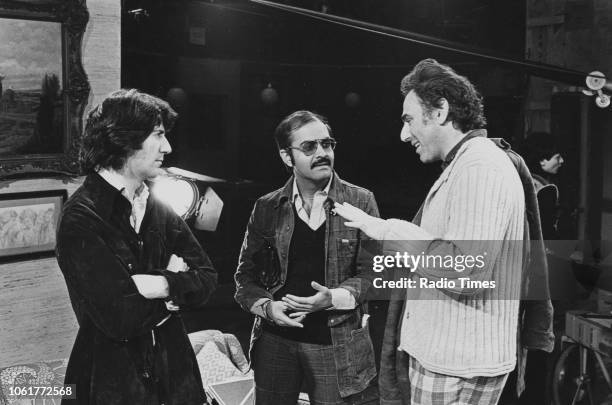 Writer Frederic Raphael and director Waris Hussein talking to actor Tom Conti on the set of the television drama 'The Glittering Prizes', January...