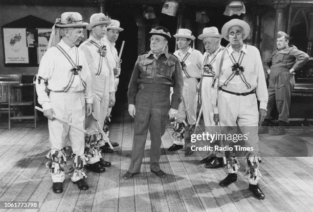 Actors Clive Dunn, Ian Lavender, Unknown, Arthur Lowe, Unknown, Arnold Ridley and John Laurie dressed as morris dancers in a scene from episode 'The...