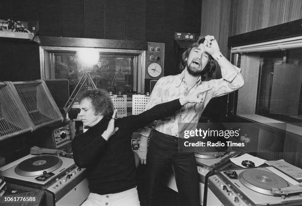 Portrait radio disc jockeys Paul Burnett and Noel Edmonds joking around in the studio, October 1974.