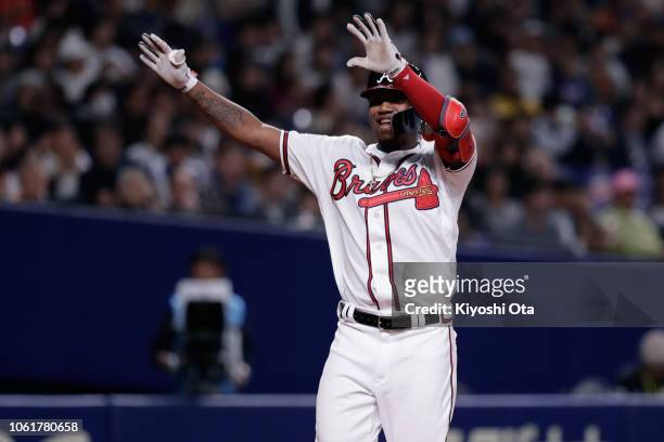 Outfielder Ronald Acuna Jr. #13 of the Atlanta Braves celebrates after hitting a solo home run in the bottom of 8th inning during the game six...