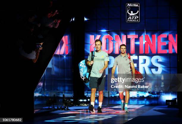 Henri Kontinen of Finland and John Peers of Australia walk onto the court ahead of their match against Jamie Murray of Great Britain and Bruno Soares...
