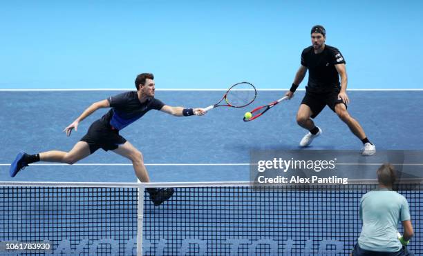 Jamie Murray of Great Britain and Bruno Soares of Brazil return the ball during their round robin match against Henri Kontinen of Finland and John...