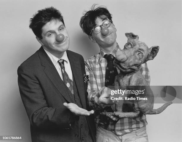 Portrait of comedian Patrick Marber and poet John Hegley wearing red noses, photographed for Radio Times in connection with the comedy television...
