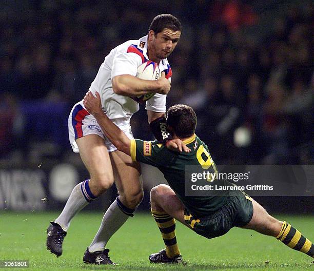 Andrew Farrell of Great Britain holds off a tackle from Danny Buderus of Australia during the Great Britain v Australia Guinness Second Test match at...