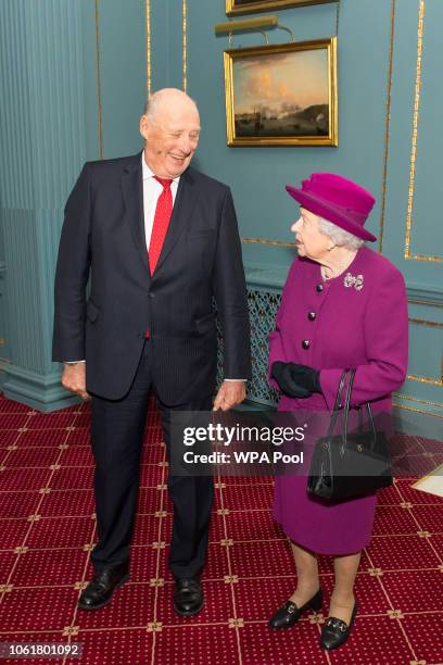 Queen Elizabeth II and King Harald V of Norway attend the Anglo-Norse Society centenary reception at The Naval & Military Club on November 15, 2018...