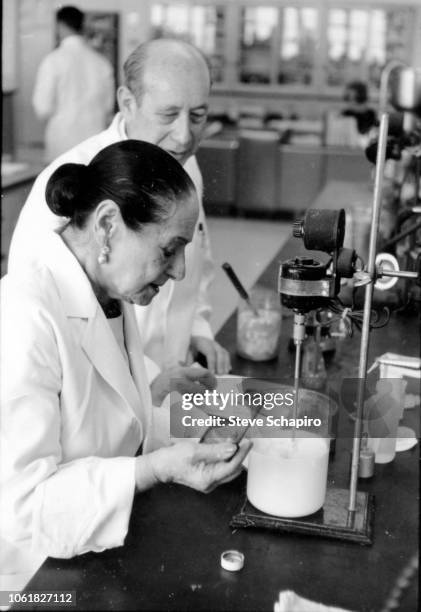 Polish-born American cosmetics entrepreneur and beautician Helena Rubinstein tests a mixture in a laboratory, New York, 1964.