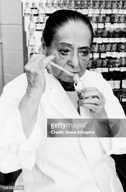 Polish-born American cosmetics entrepreneur and beautician Helena Rubinstein tests perfume in a laboratory, New York, 1964.