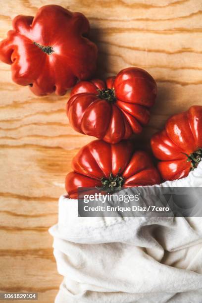 tiny heirloom tomatoes in cloth bag, vertical - tomate coeur de boeuf fotografías e imágenes de stock