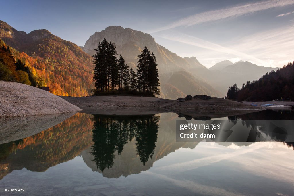 Beautiful reflection at Lake Predil, Italy with colorful trees in background in autumn season